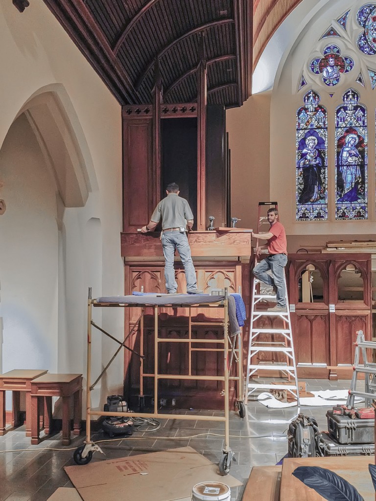 New Holland Church Furniture staff installing the organ's casework