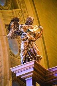 Detail of carved angel atop gallery organ casework